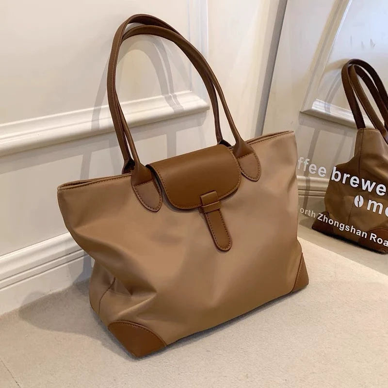 Bolsa tote prática de grande capacidade para estudantes femininas, versátil para deslocamentos, bolsa feminina de ombro único em tecido Oxford e nylon, bolsa tote transfronteiriça.