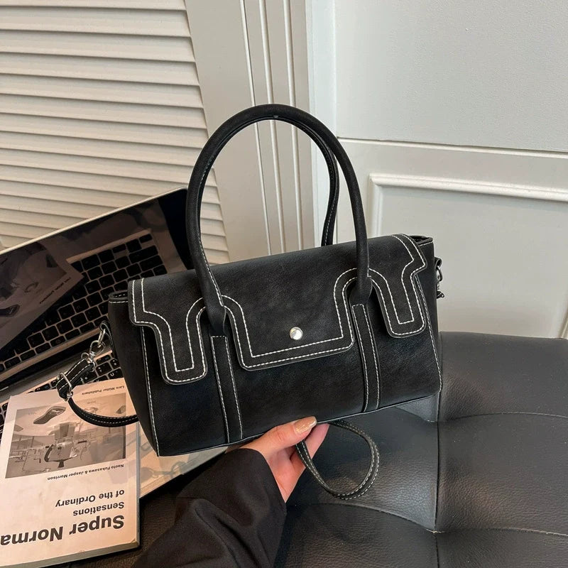 Bolsas de nicho de alto padrão para mulheres, nova coleção primavera/verão 2026, bolsa vintage versátil de ombro e transversal, bolsa feminina popular.