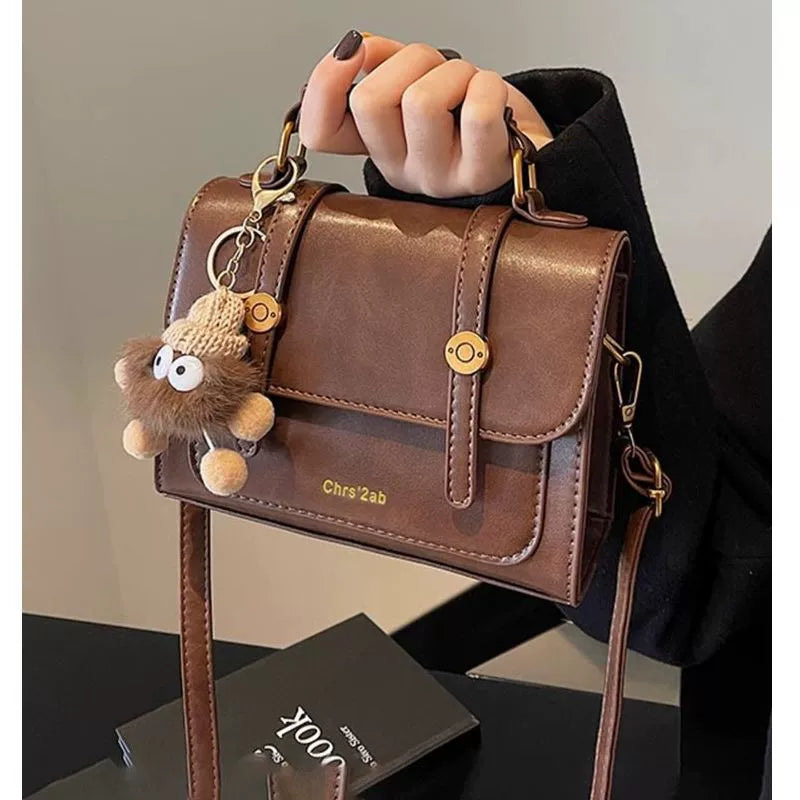 Bolsa pequena retrô de textura sofisticada, nova bolsa transversal versátil feminina, bolsa quadrada pequena de mão super moderna e popular.
