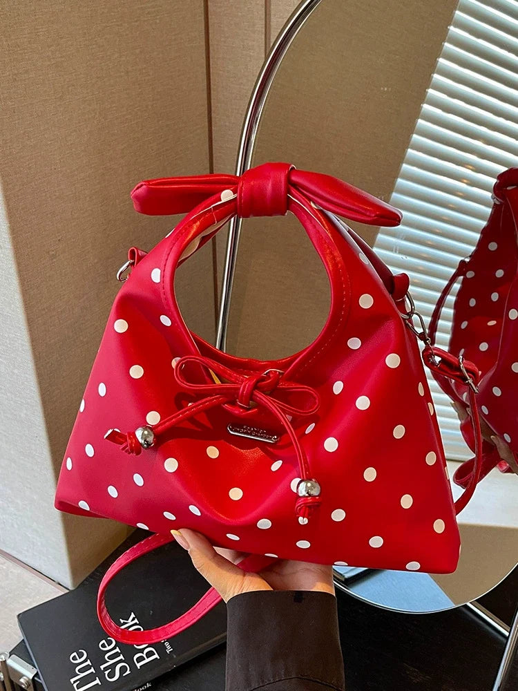 A bolsa feminina da moda deste ano com laço e bolinhas, uma novidade elegante e versátil de 2026. Uma bolsa transversal chique que também pode ser usada como bolsa de ombro ou carregada como bolsa de mão.