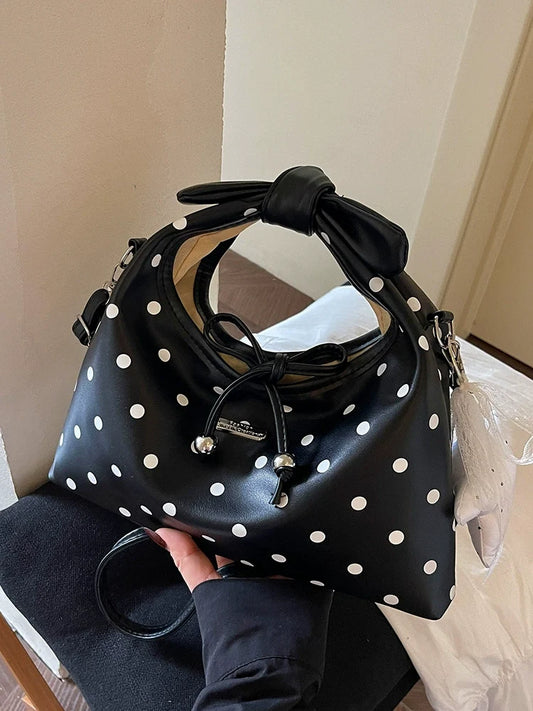 A bolsa feminina da moda deste ano com laço e bolinhas, uma novidade elegante e versátil de 2026. Uma bolsa transversal chique que também pode ser usada como bolsa de ombro ou carregada como bolsa de mão.
