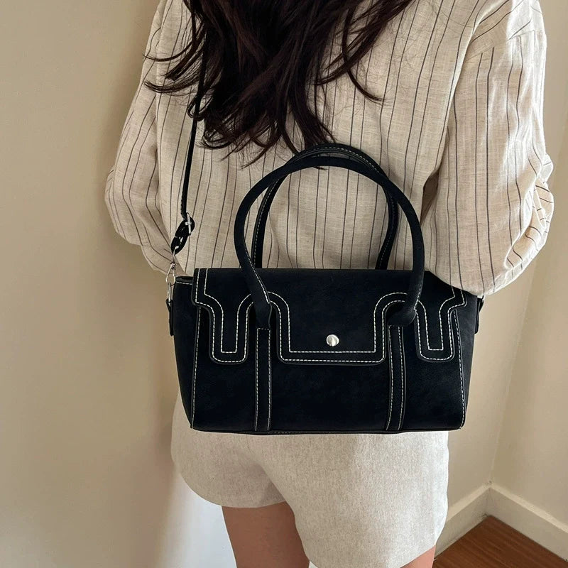Bolsas de nicho de alto padrão para mulheres, nova coleção primavera/verão 2026, bolsa vintage versátil de ombro e transversal, bolsa feminina popular.