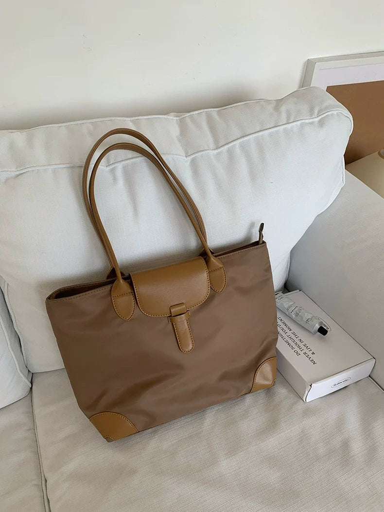 Bolsa tote prática de grande capacidade para estudantes femininas, versátil para deslocamentos, bolsa feminina de ombro único em tecido Oxford e nylon, bolsa tote transfronteiriça.