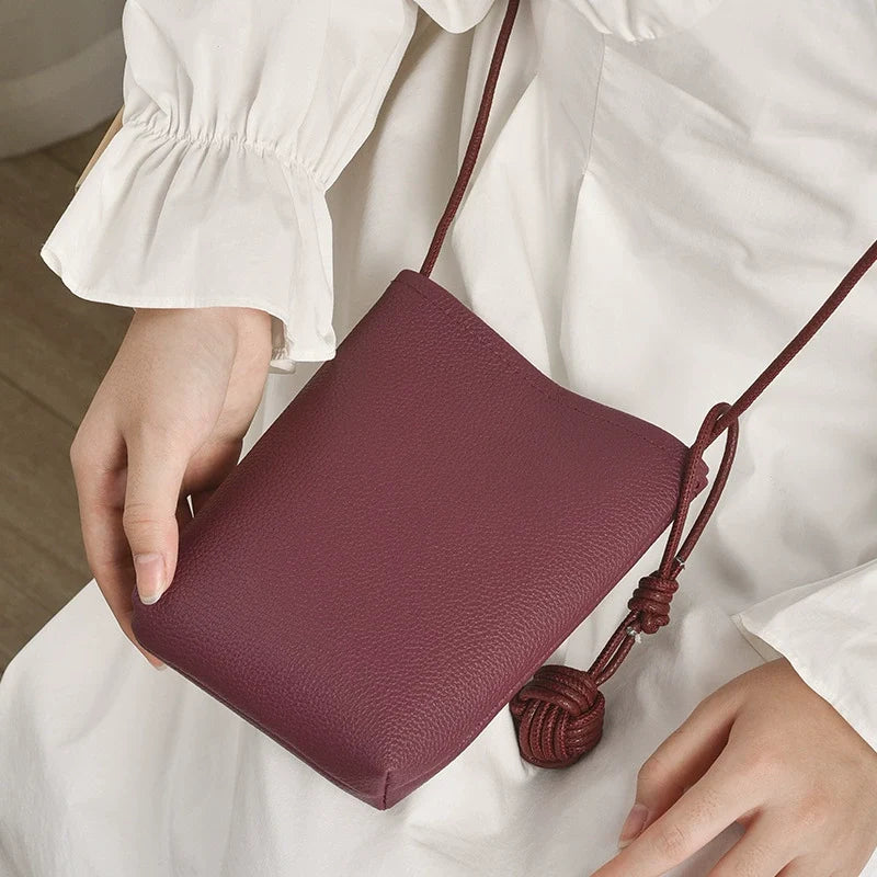 Versátil literário e artístico pequeno pingente de bola pequena fresca super popular bolsa crossbody para celular couro macio fofo mini bolsa pequena para mulheres
